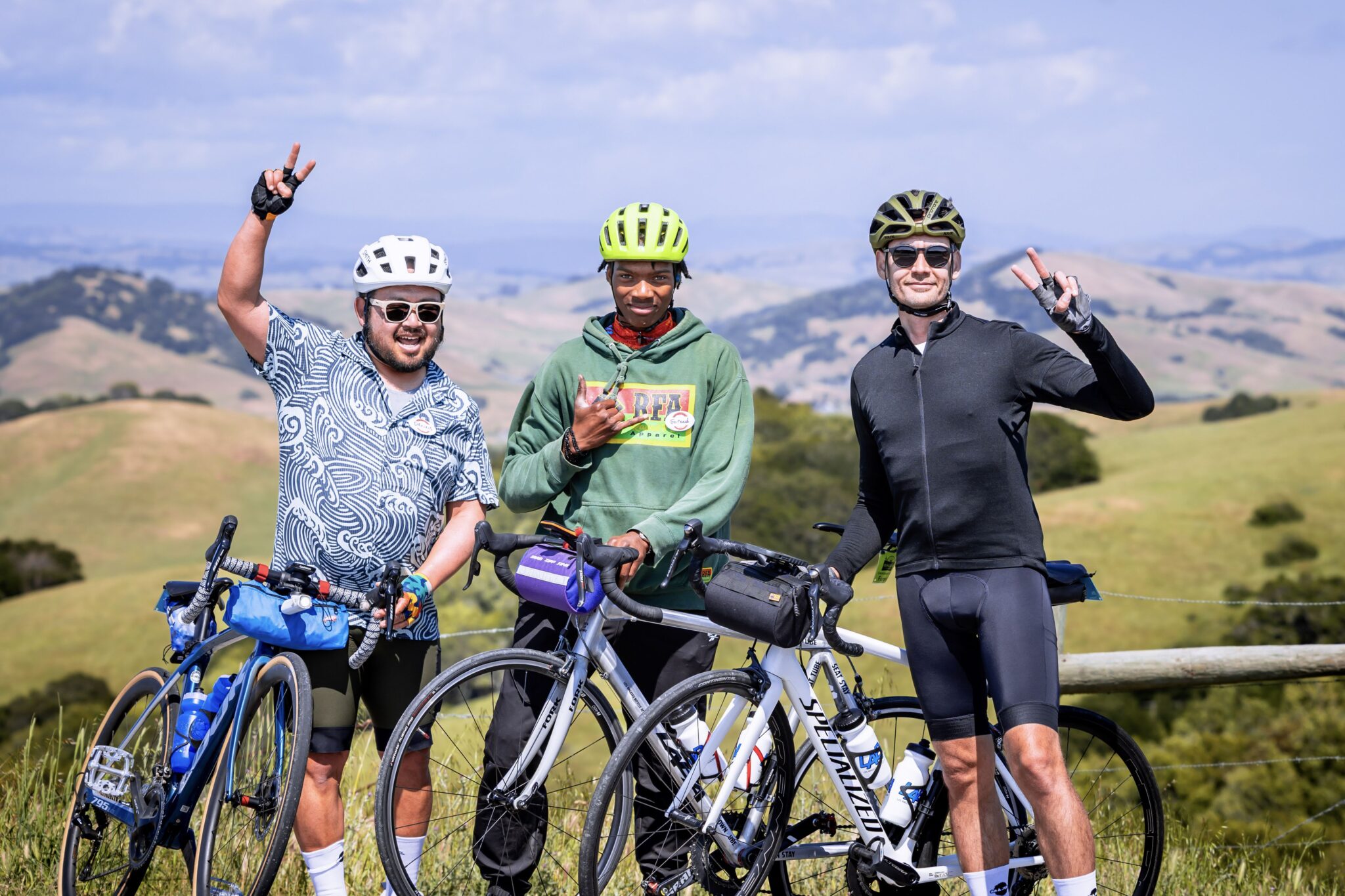 Three Green Fondo riders posing with beautiful Sonoma County hillside in th background.